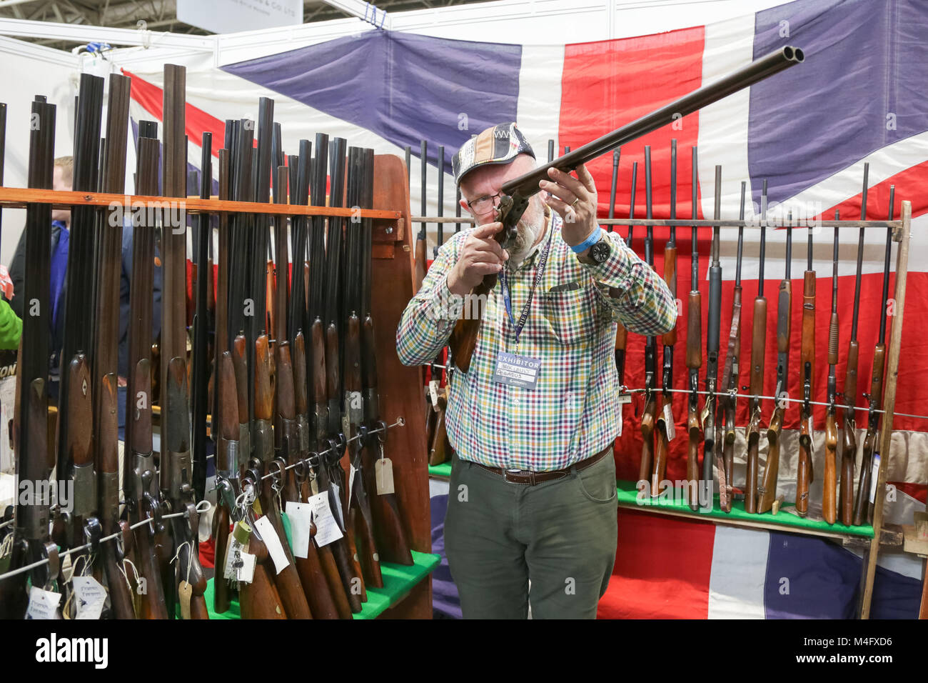 Gunsmith examining a shotgun Stock Photo