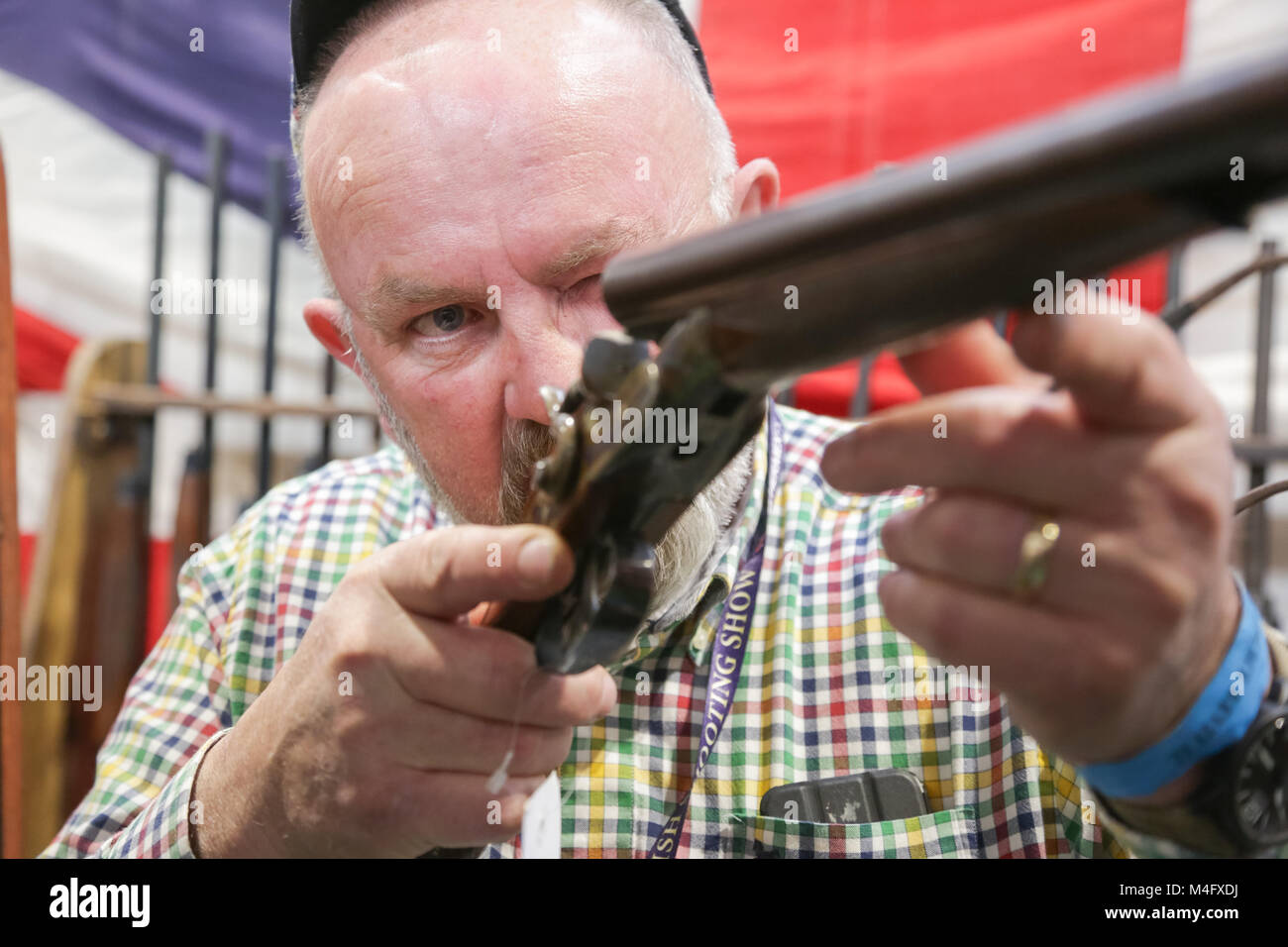 Gunsmith examining a shotgun Stock Photo