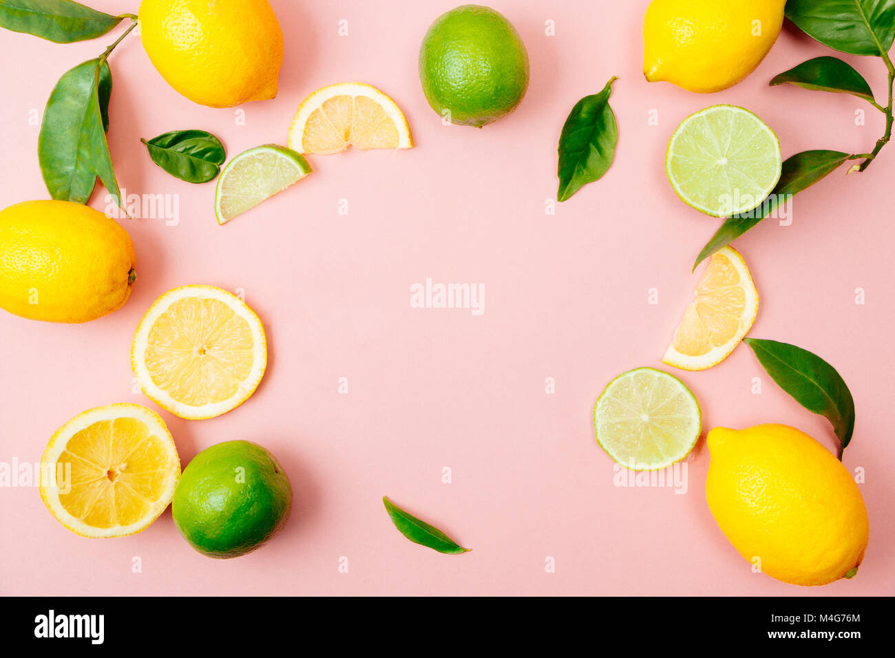 Flat lay of citrus fruits like lime and lemon with lemon tree leaves on