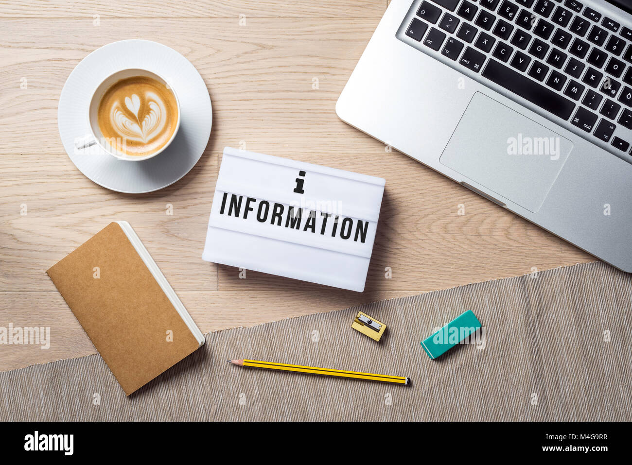 Information Writing In Lightbox Lying On Wooden Desk With Office