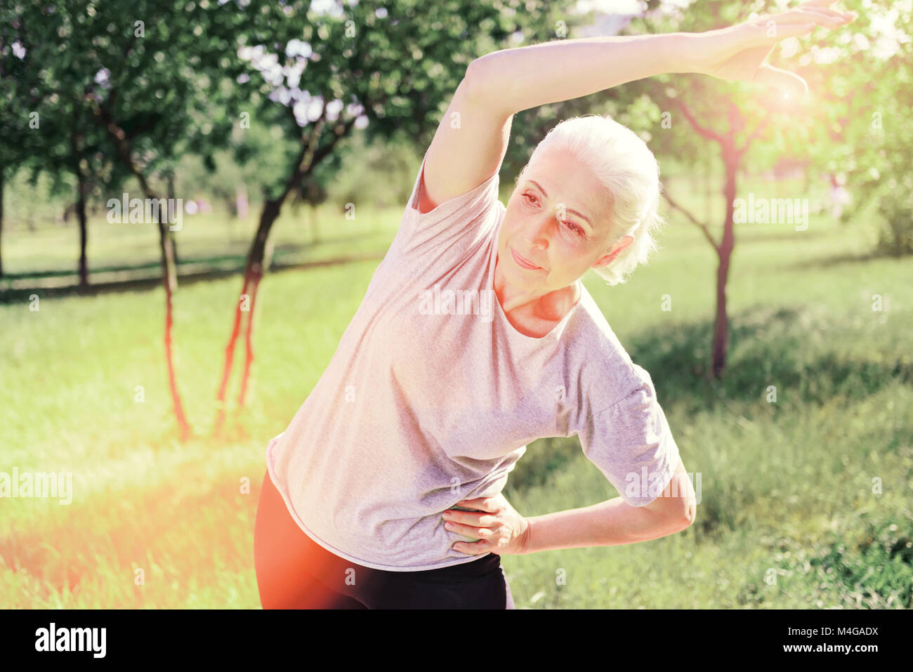 Elderly woman busy with exercises Stock Photo Alamy