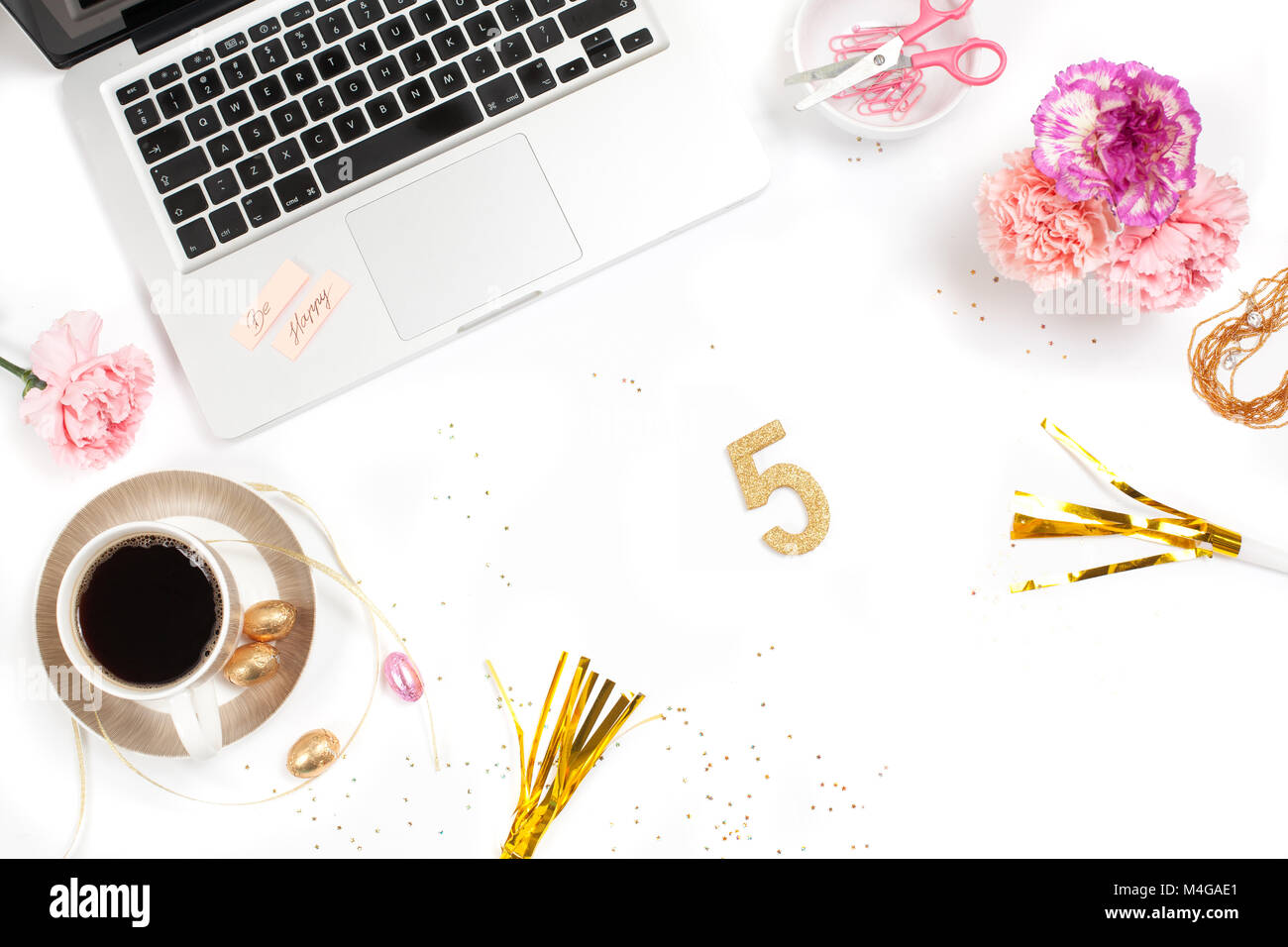 White, gold and pink womens office desk table with a lot of things on it. Top view with copy space.good place to work Stock Photo