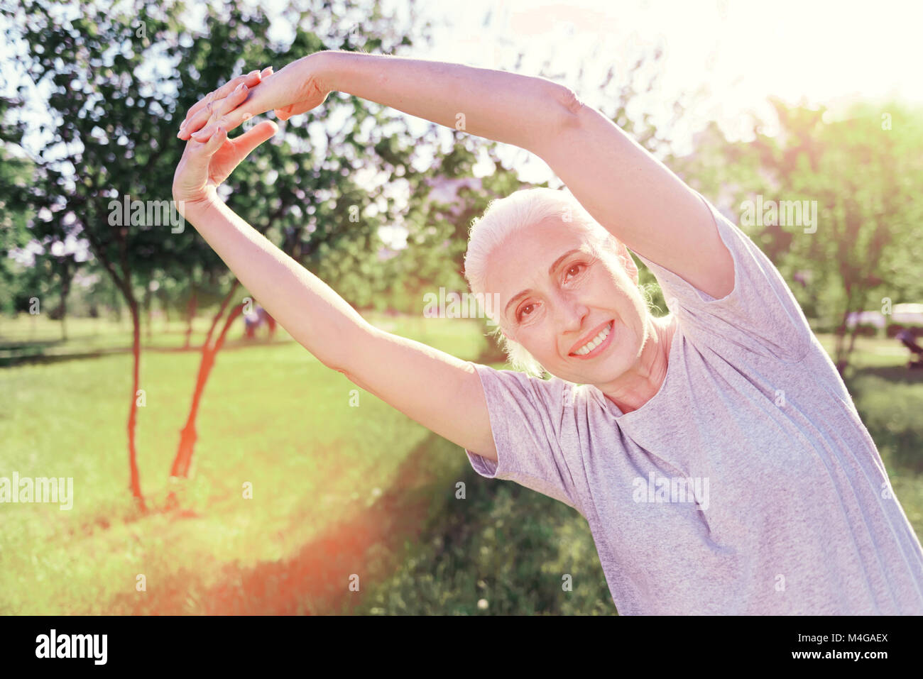 Close up of amused woman doing exercises Stock Photo