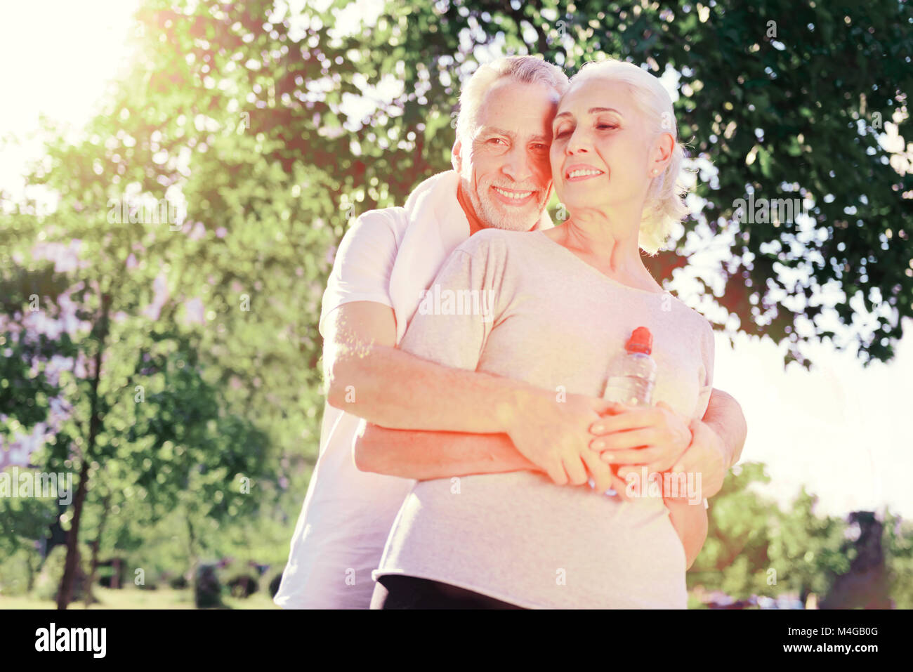 Smiling husband hugging his wife Stock Photo