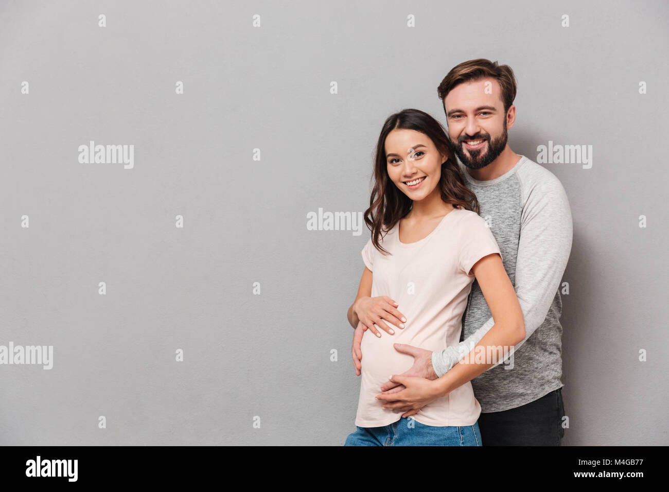 Young man hugging his pregnant wife hi-res stock photography and images ...
