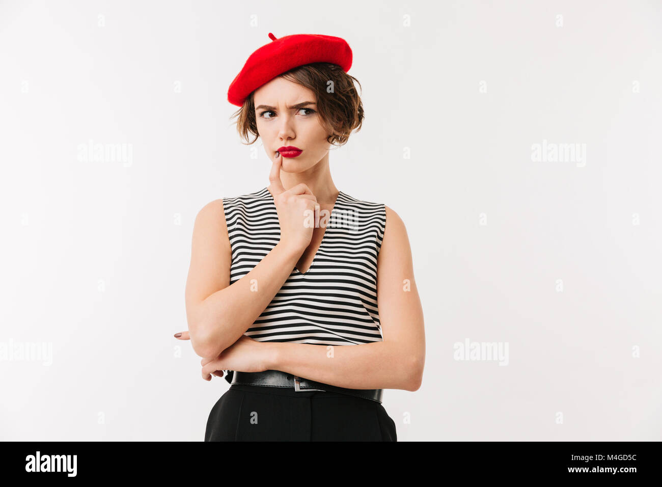 Portrait of a pensive woman wearing red beret looking away isolated