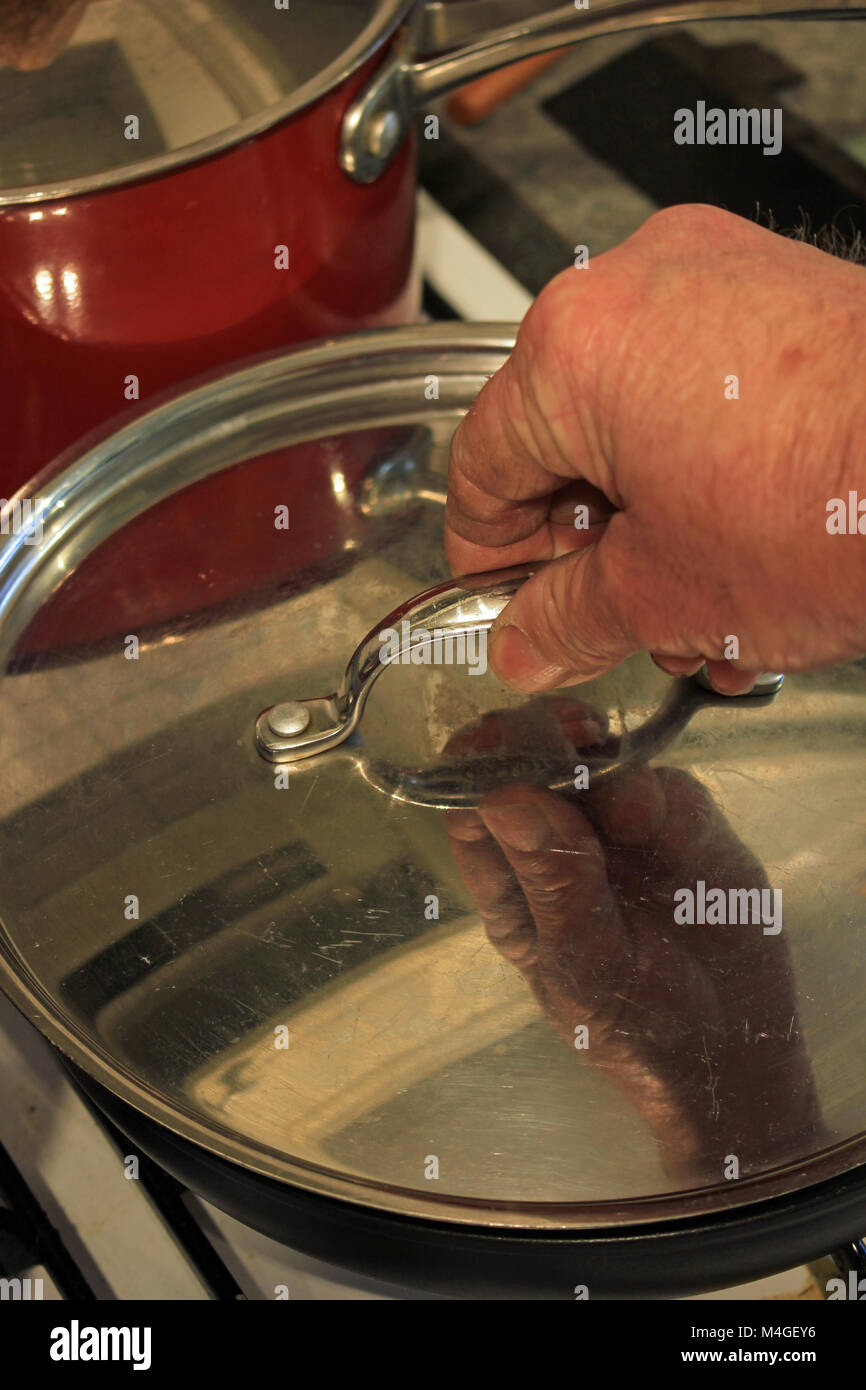 Lifting a hot lid off a pan hires stock photography and images Alamy