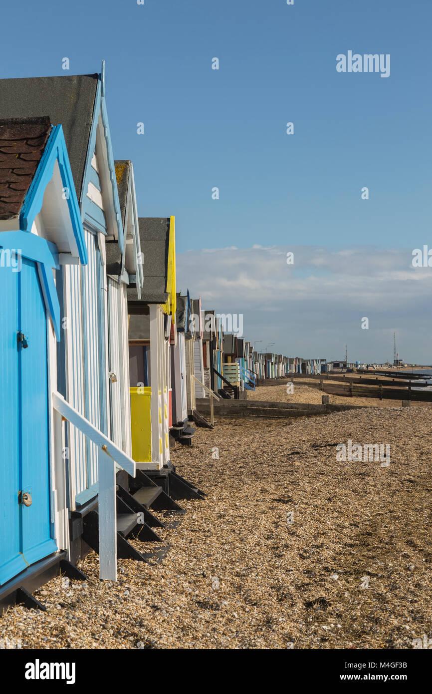 Looking to Mouth of Thames Estuary Colourful Beach Huts at Thorpe Bay in Essex on a Very Sunny February Afternoon Stock Photo