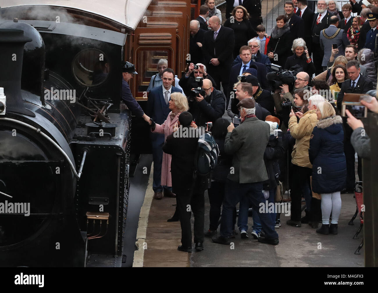The Duchess of Cornwall speaks to the driver as she boards a steam train at The Railway Station in Haworth. Stock Photo