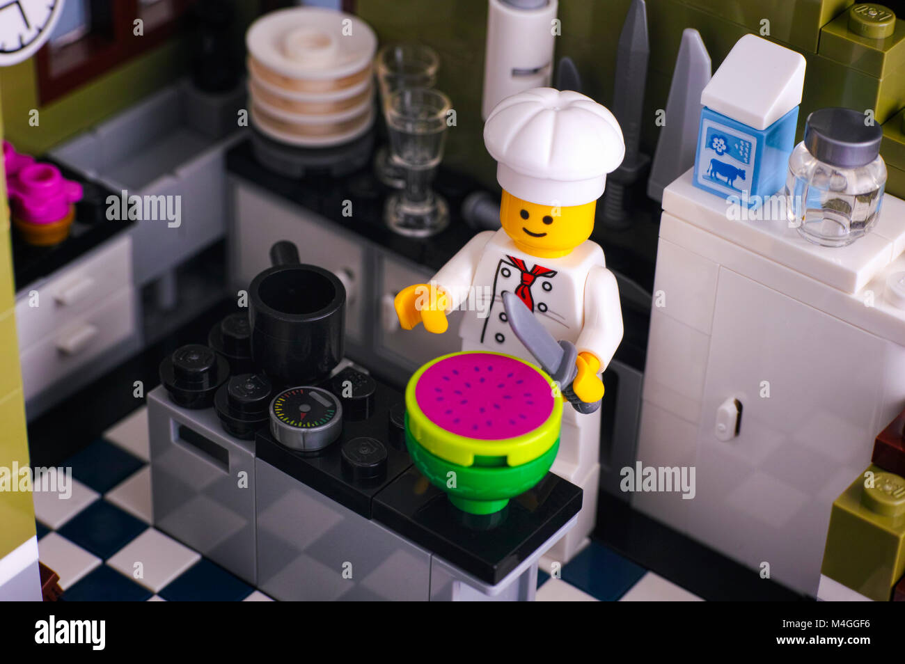 Tambov, Russian Federation - January 04, 2018 Lego chef cutting watermelon in the kitchen. Studio shot. Stock Photo