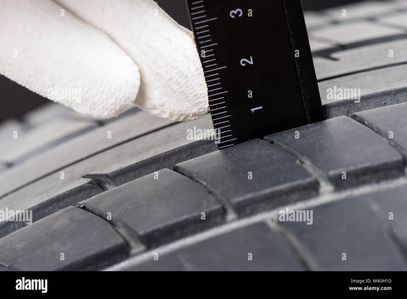 checking the depth of car tire tread Stock Photo Alamy