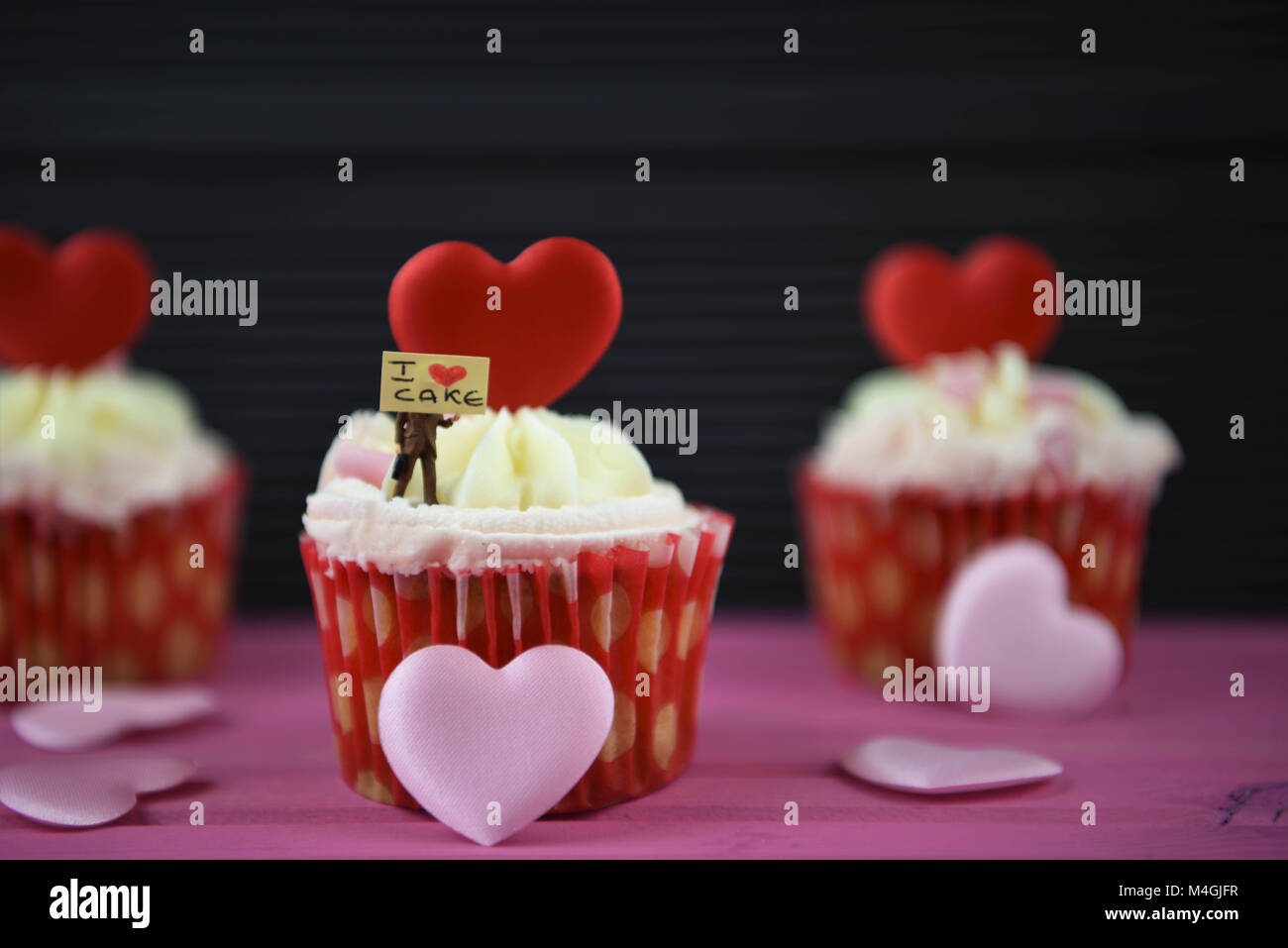 food cupcakes with love heart shapes and miniature sign for i love cake Stock Photo