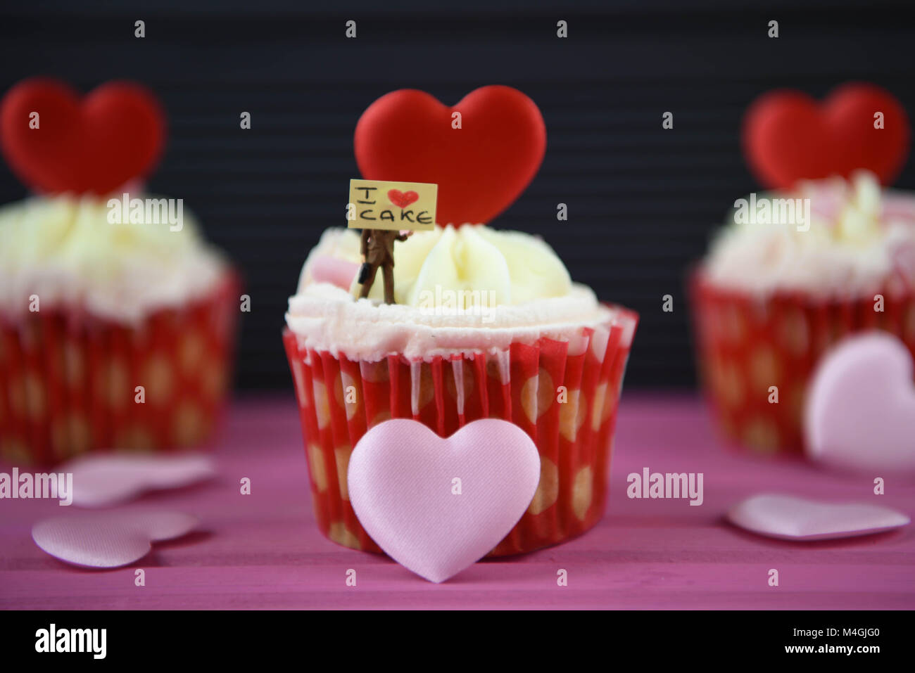 food cupcakes with love heart shapes and miniature sign for i love cake Stock Photo
