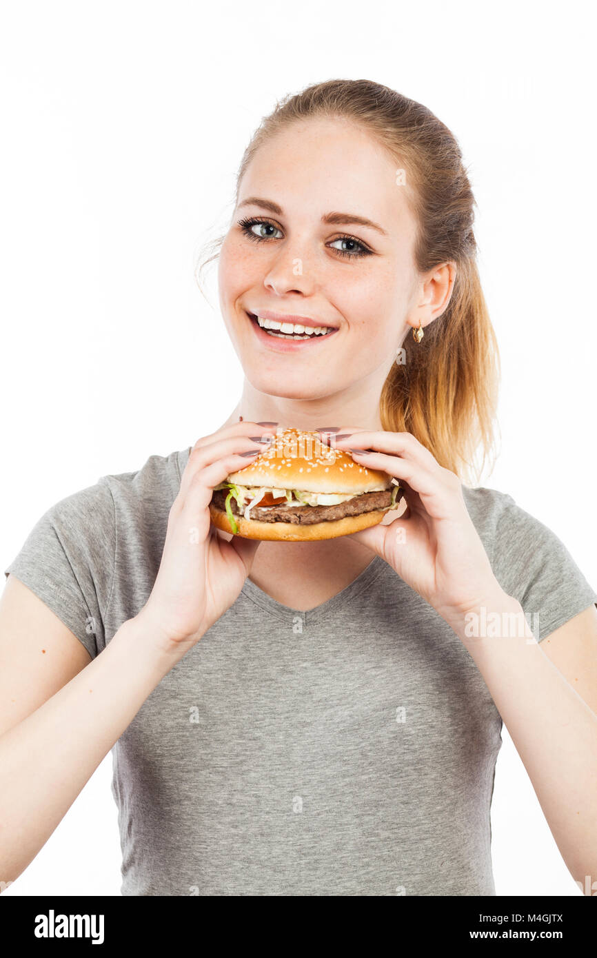 Portrait of a cute young woman holding a burger, isolated on white Stock Photo