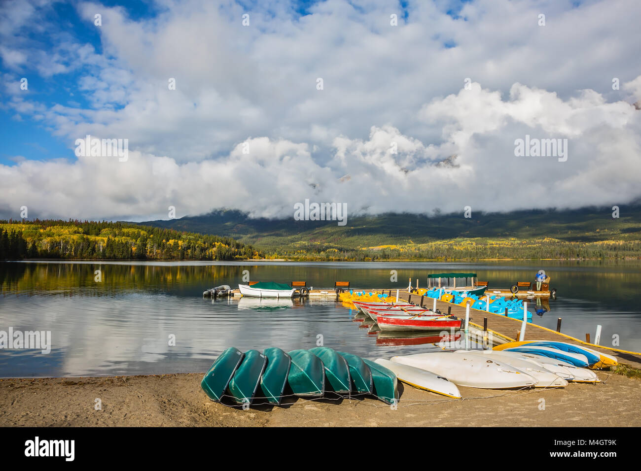Wooden boat dock with moored boats Stock Photo - Alamy