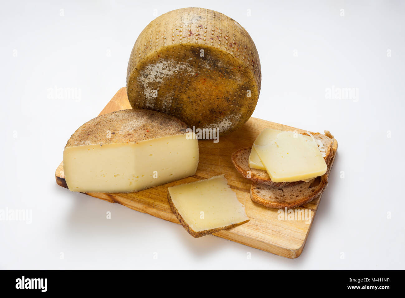 Abruzzo pecorino cheese on wooden cutting board. Still life on white background. Abruzzo, Italy, Europe Stock Photo