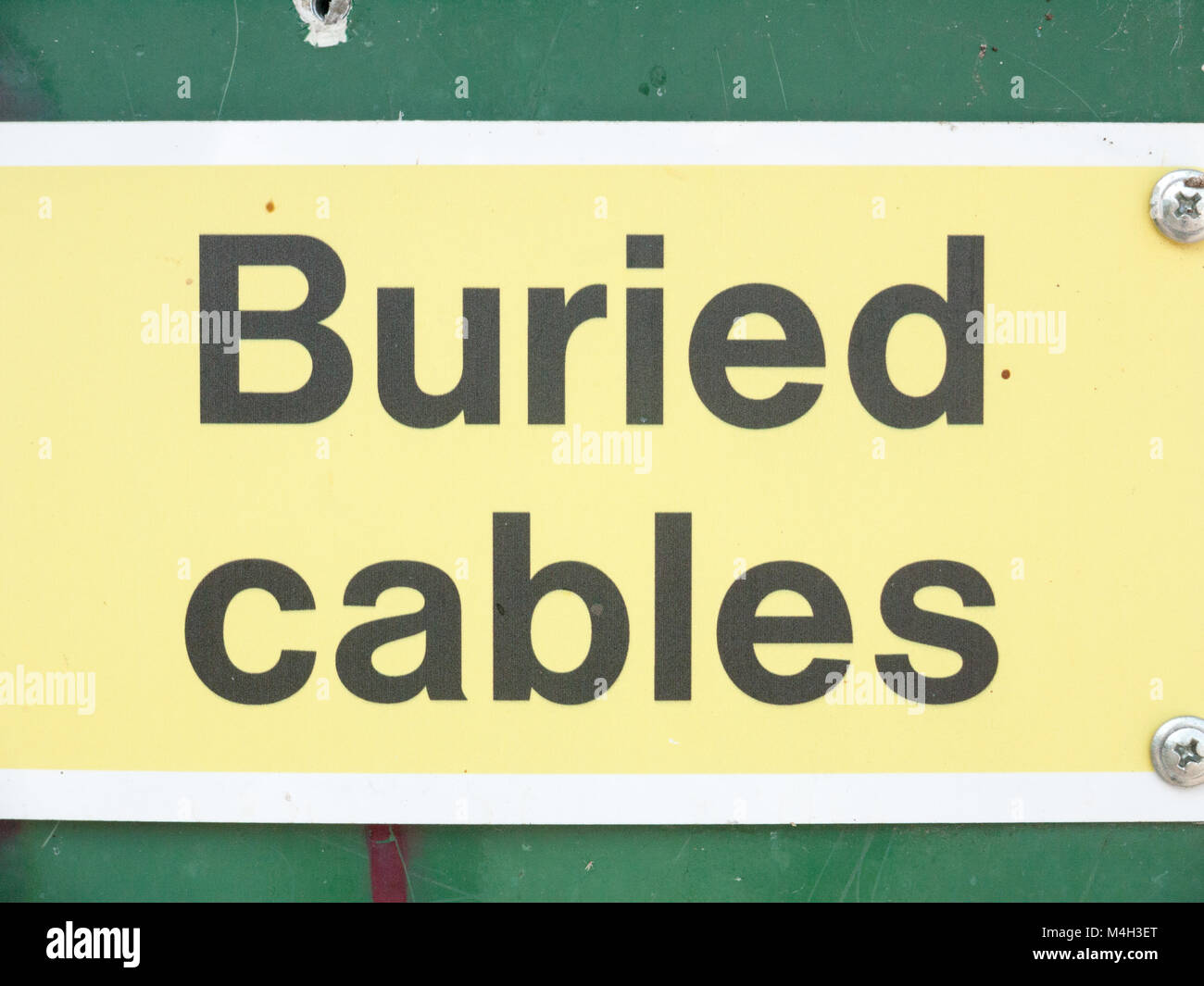 buried cables warning sign close up Stock Photo