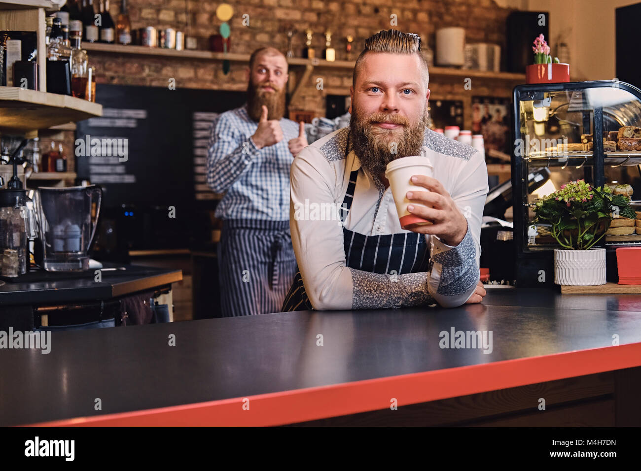 https://c8.alamy.com/comp/M4H7DN/portrait-of-redhead-bearded-barista-male-at-bar-stand-in-a-coffee-M4H7DN.jpg