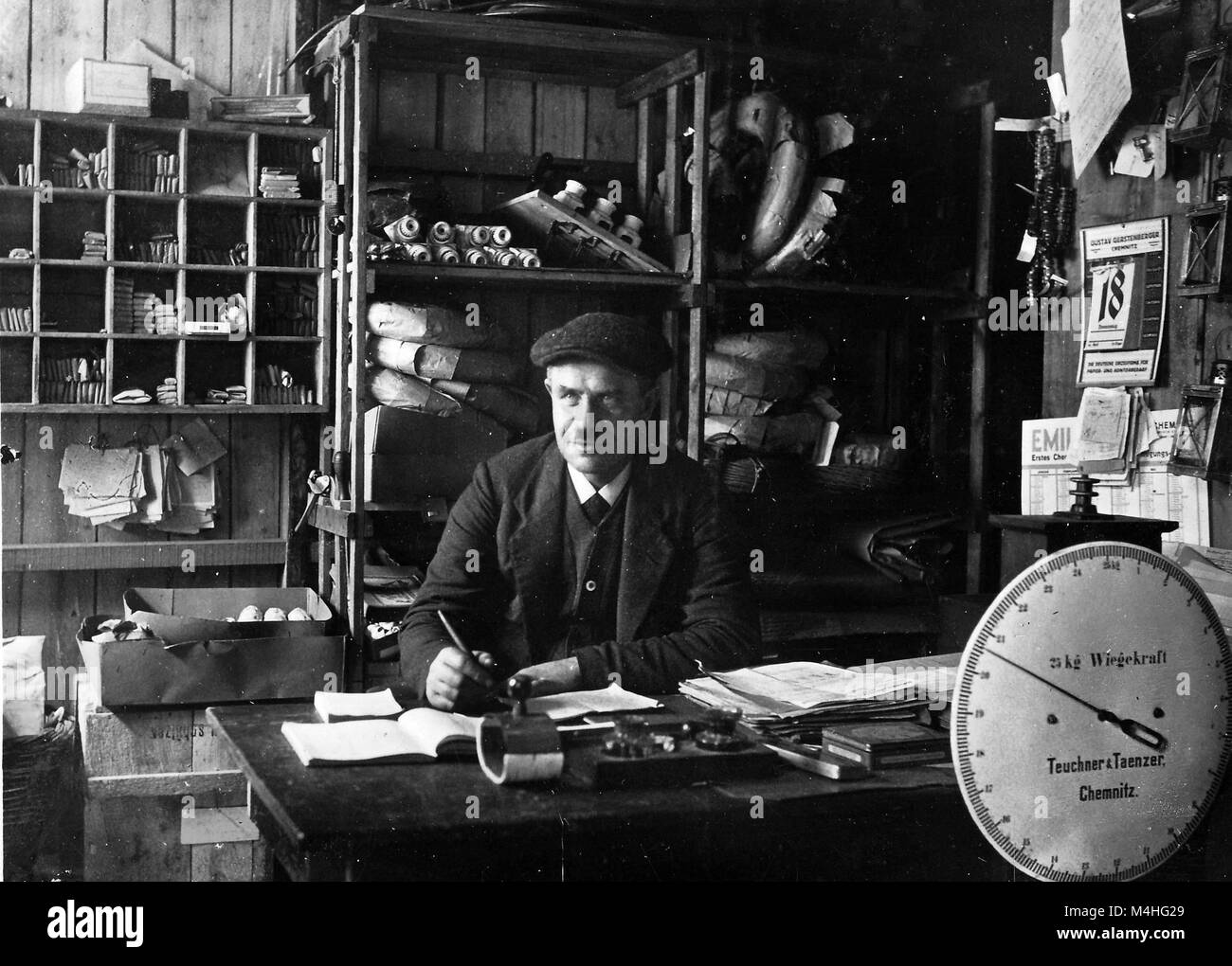 A man is working at a desk in a post office in Erftstadt Stock Photo