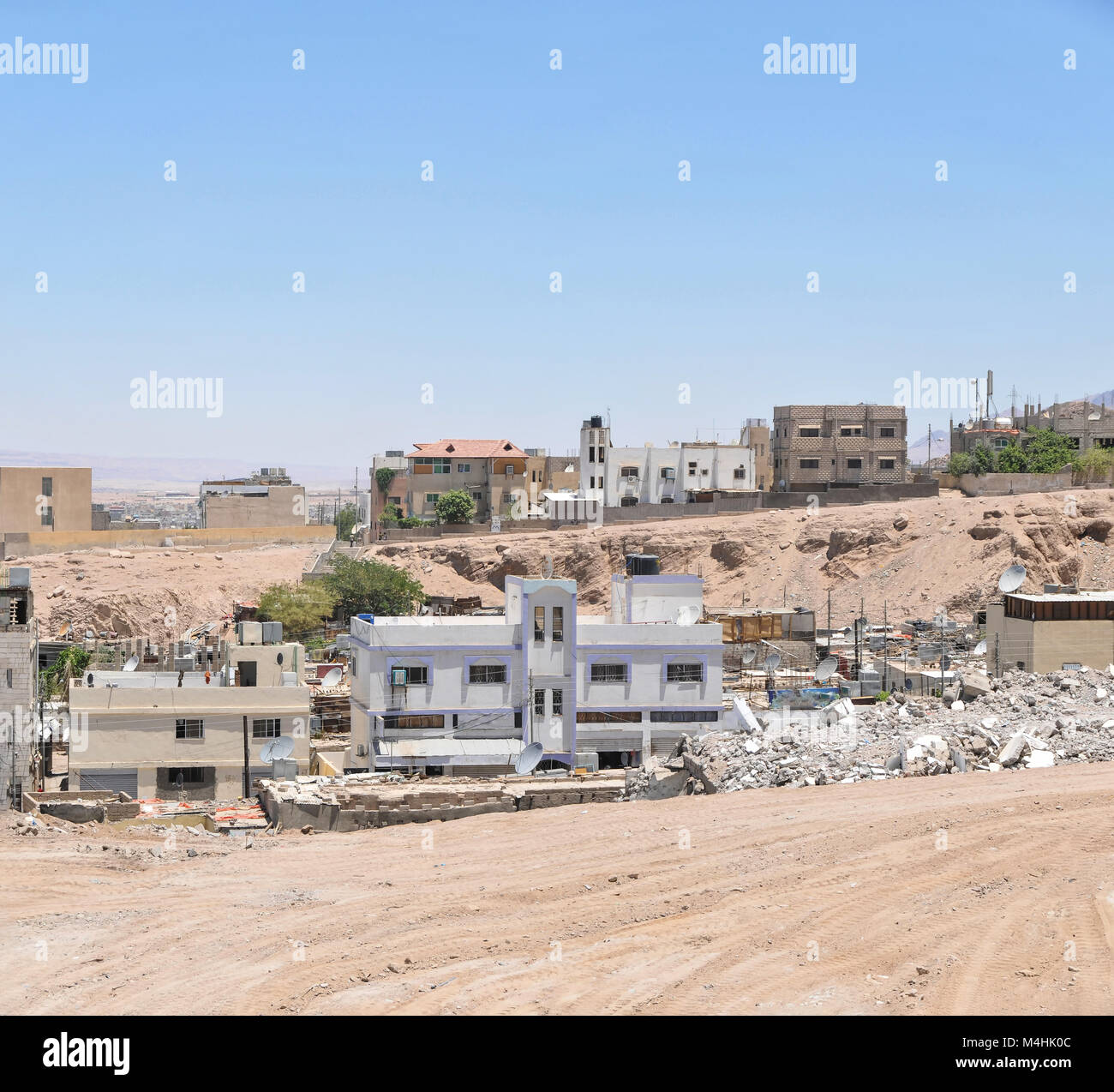 An informal settlement demolished in Aqaba Jordan with modern houses in