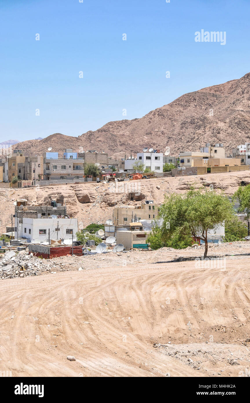 An informal settlement demolished in Aqaba Jordan with modern houses in