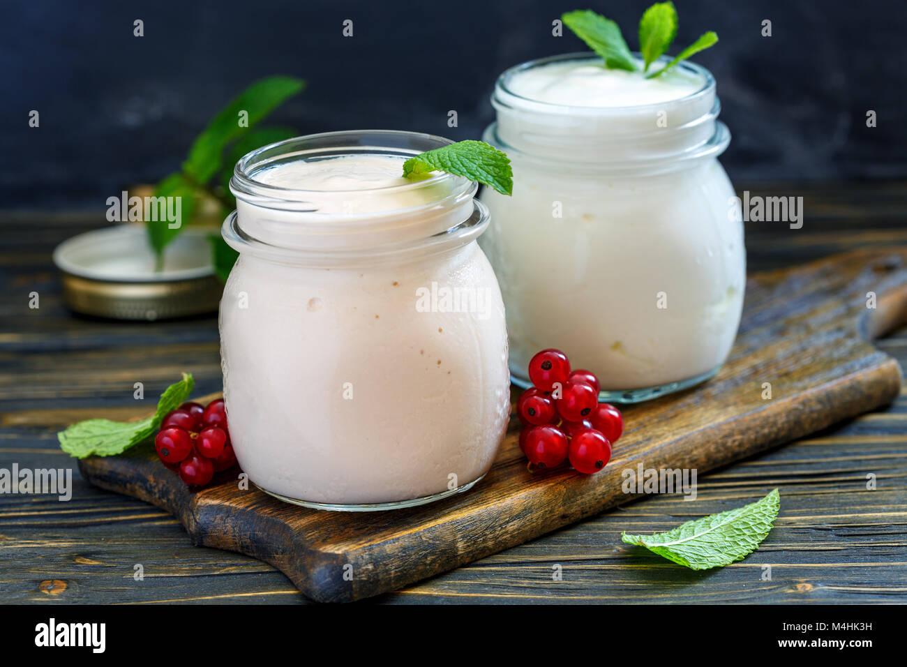 Jars with melted sour milk and natural yoghurt. Stock Photo