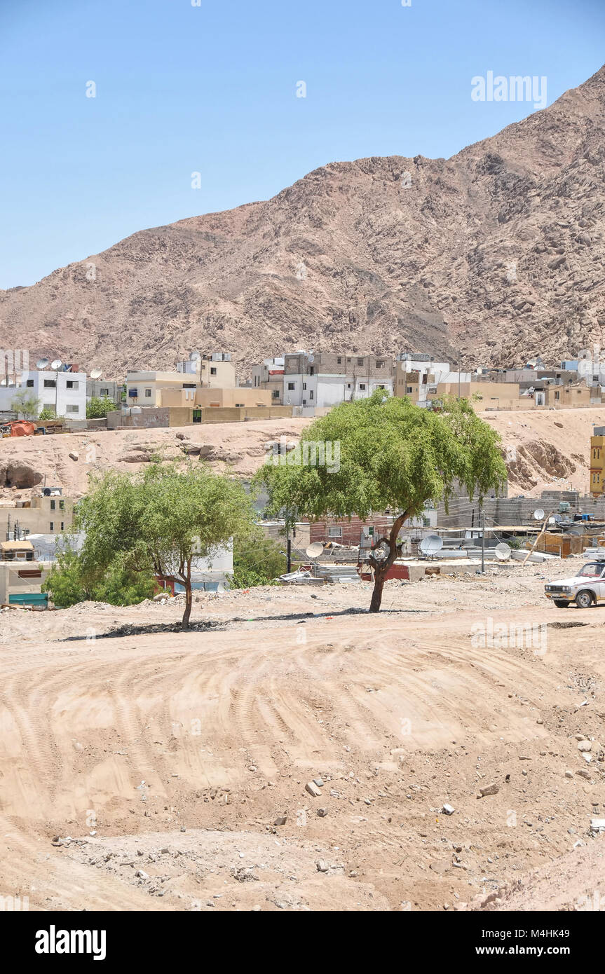 An informal settlement demolished in Aqaba Jordan with modern houses in