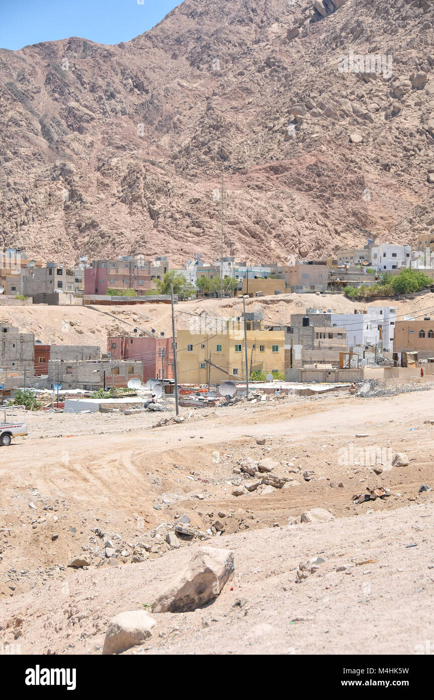 An informal settlement demolished in Aqaba Jordan with modern houses in