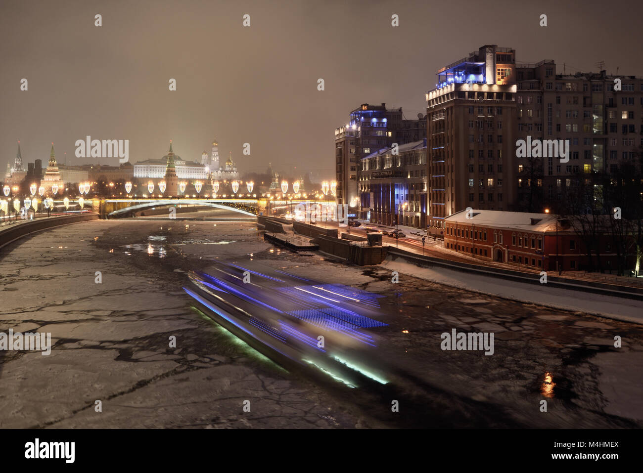 Moscow River, Variety Theatre (House on the Embankment) and the Moscow Kremlin, night view. Stock Photo
