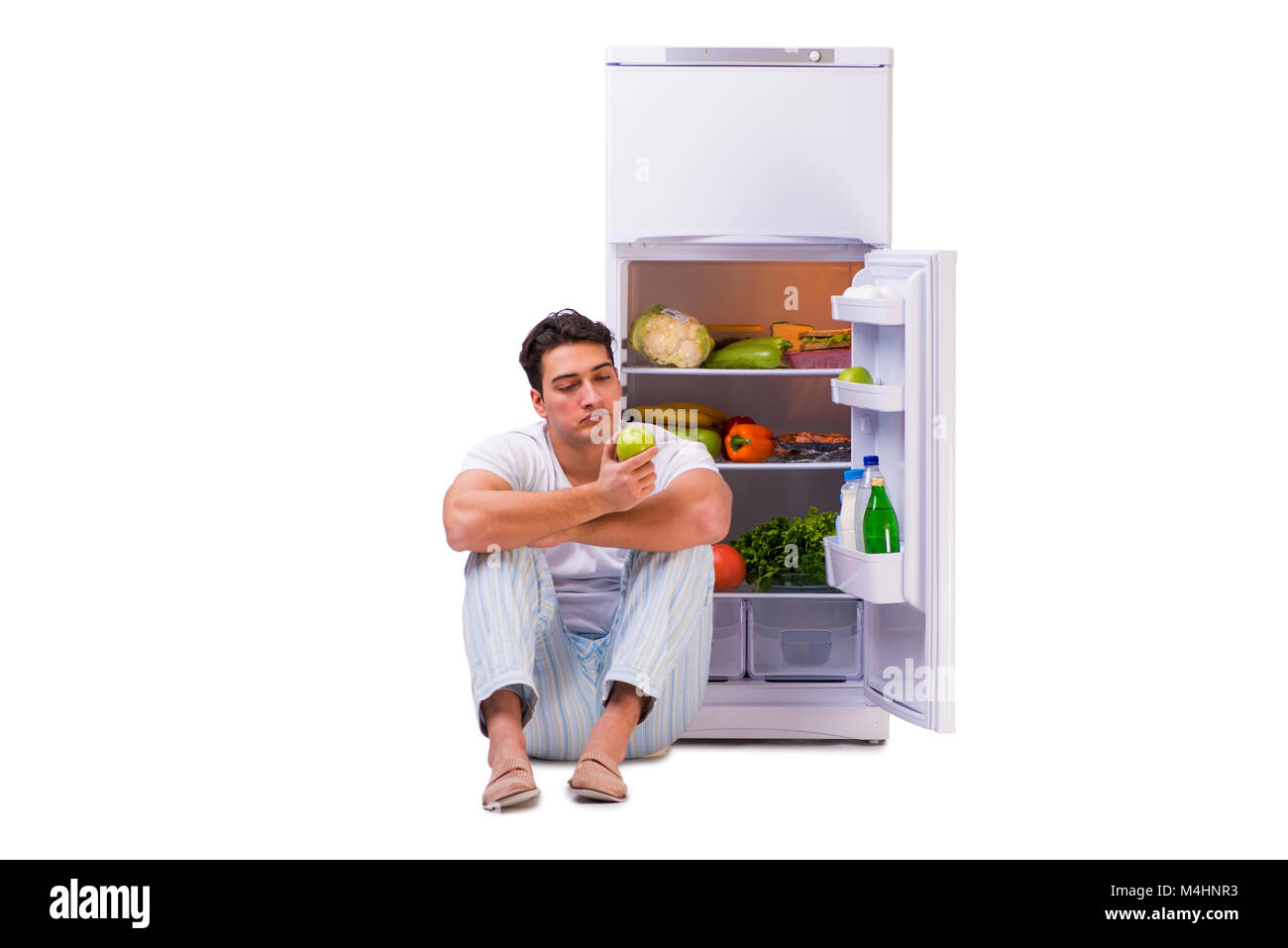 Man next to fridge full of food Stock Photo