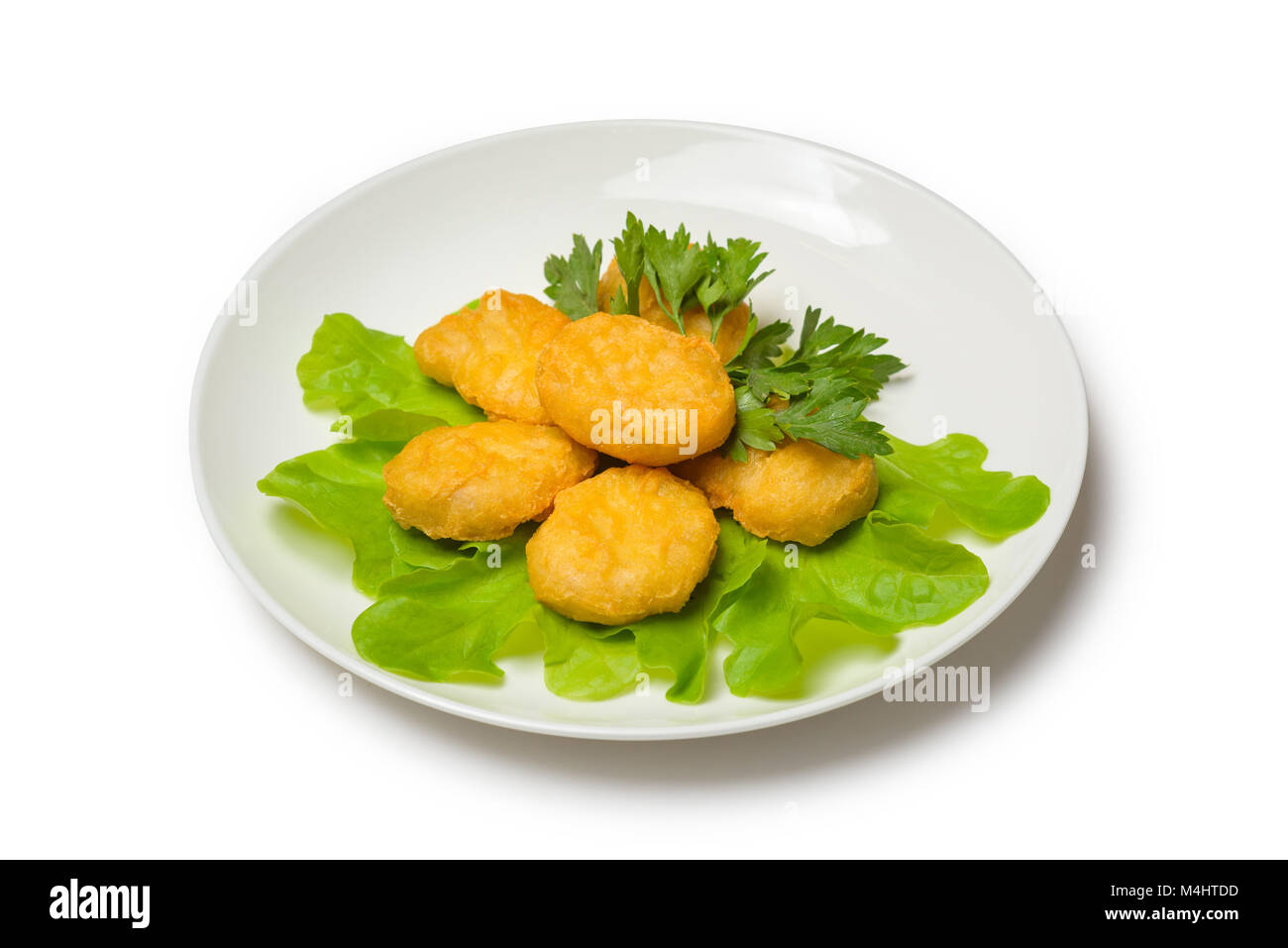 Chicken nagets with lettuce on a plate on a white background Stock Photo