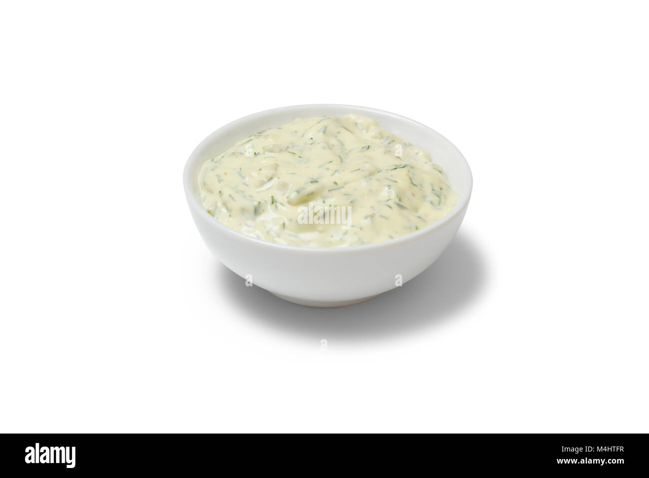 Garlic sauce in a gravy boat on white background Stock Photo