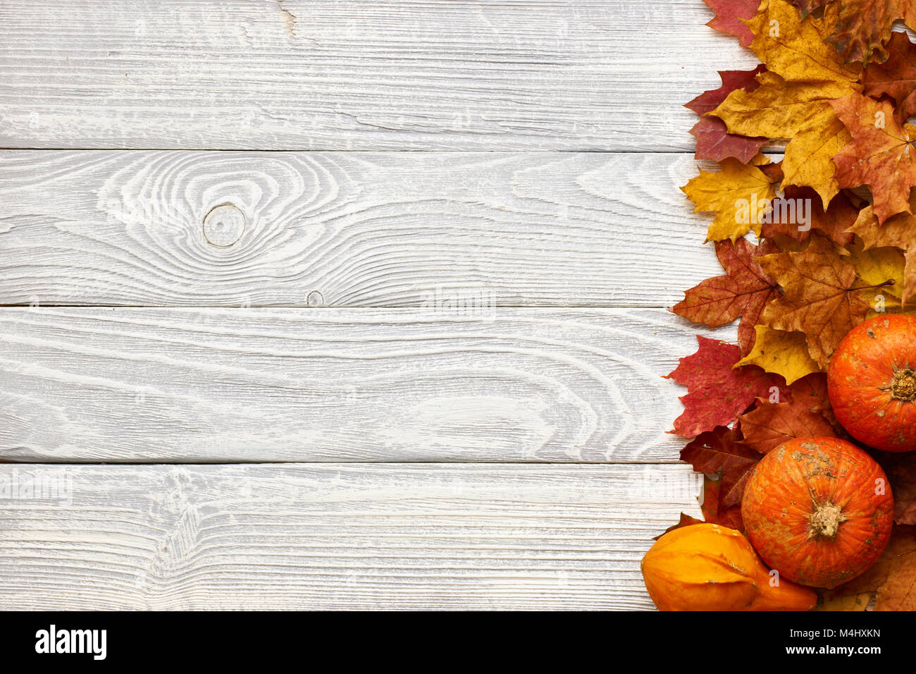 Autumn leaves and pumpkins over old wooden background Stock Photo - Alamy