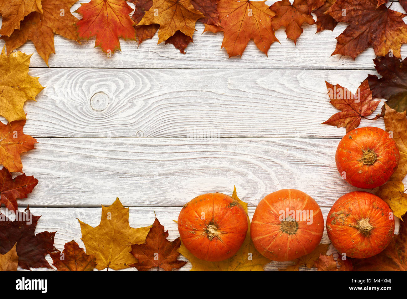Autumn leaves and pumpkins over old wooden background Stock Photo - Alamy