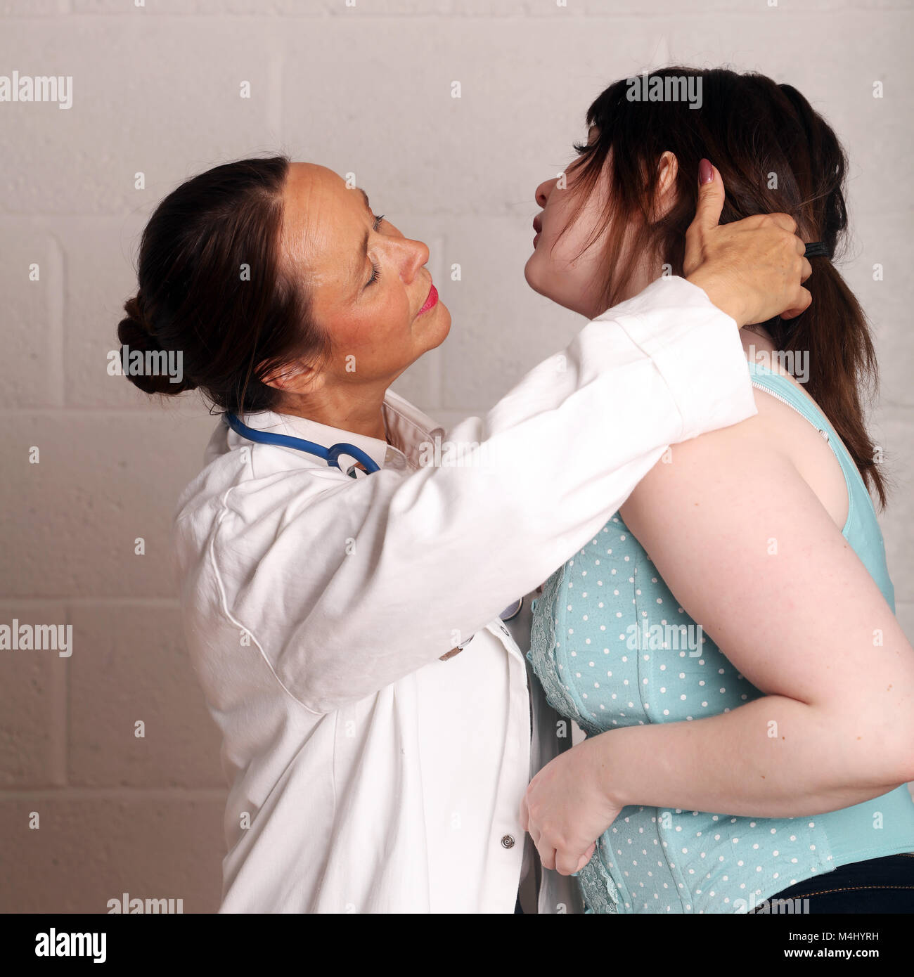 August 2017 - A young woman and a small mature doctor together. Stock Photo