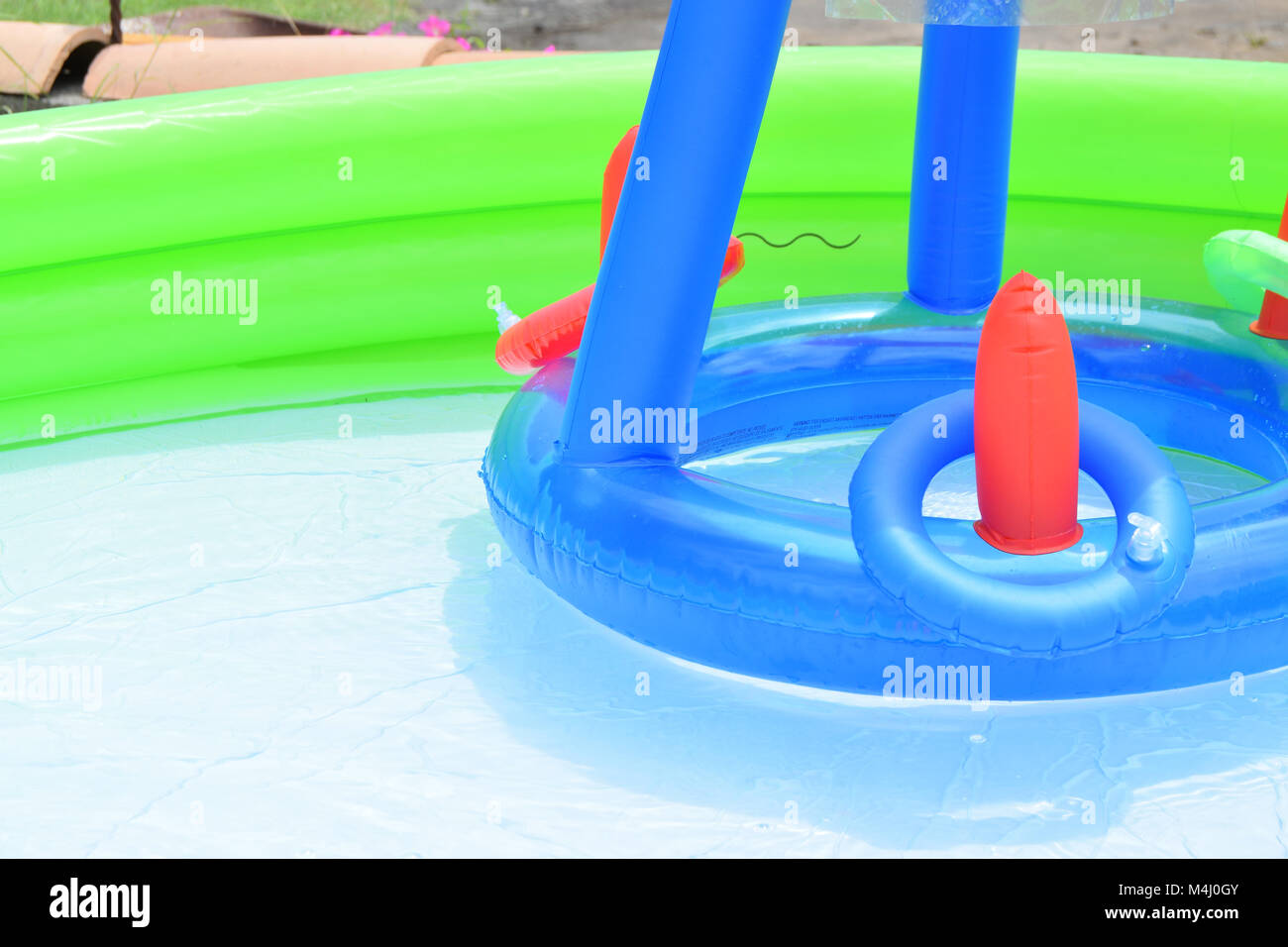 Inflatable swimming pool full of water with various children's games Stock Photo