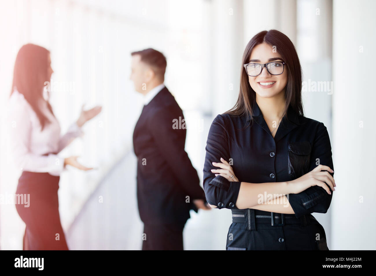 A business woman leading a team in the office Stock Photo - Alamy