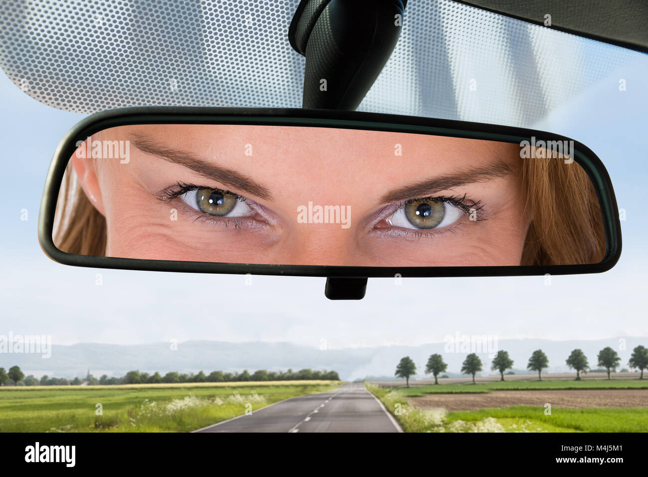 Close-up Of A Woman Eye On The Rear View Mirror Of A Car Stock Photo ...