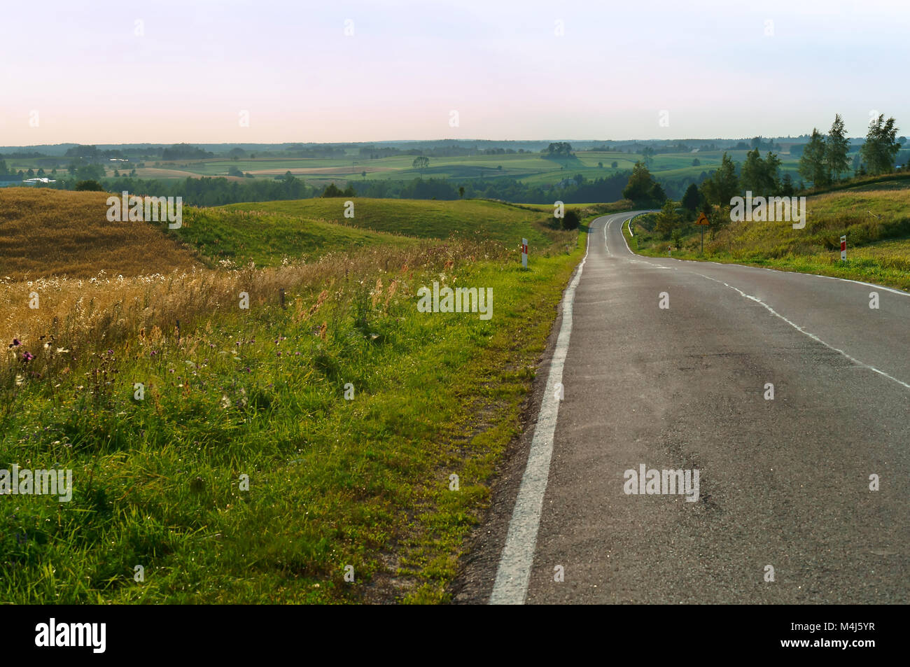 the endless path of descents and ascents in the road, a long road in the journey Stock Photo