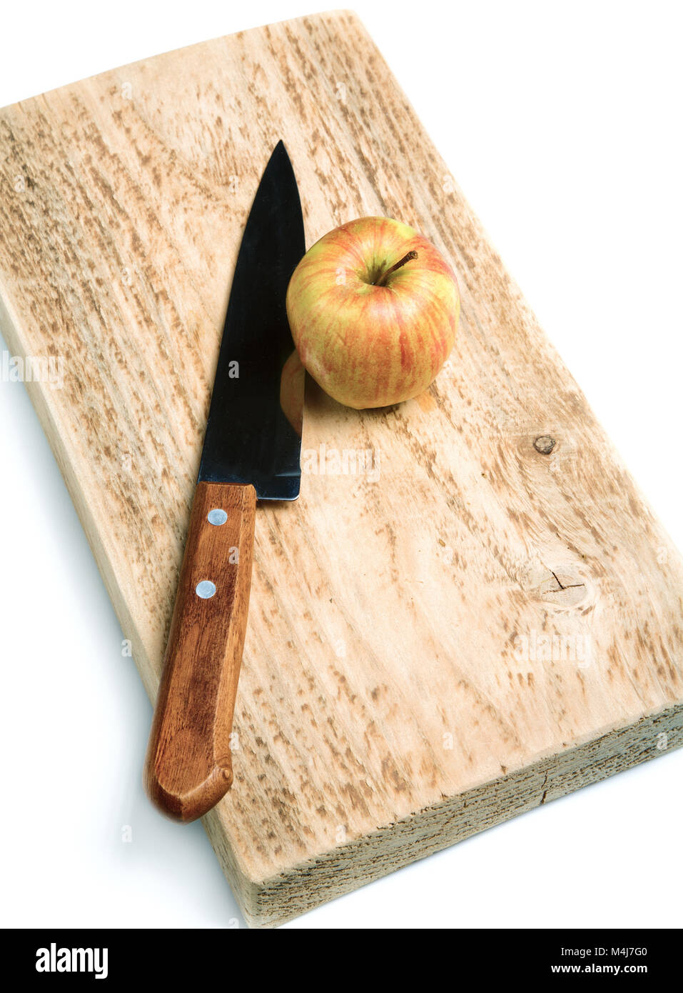 Knife and an apple on a cutting board isolated Stock Photo