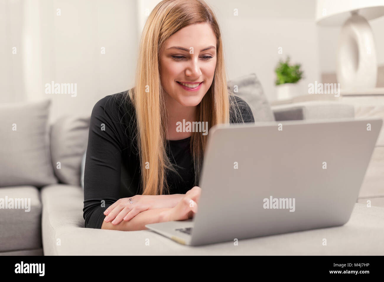 Beautiful woman using laptop living hi-res stock photography and images ...
