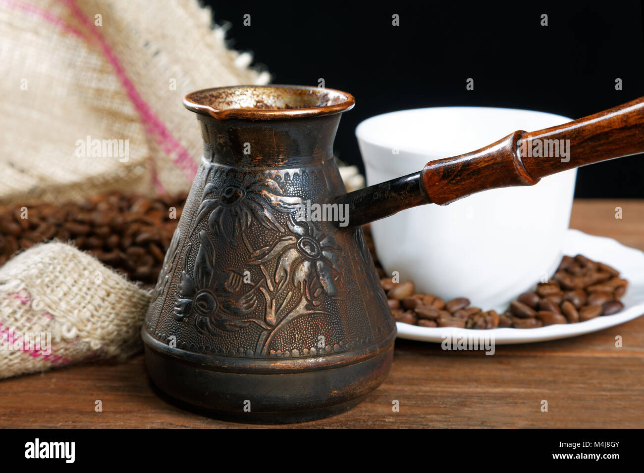 https://c8.alamy.com/comp/M4J8GY/turka-with-coffee-on-the-table-next-to-coffee-beans-M4J8GY.jpg