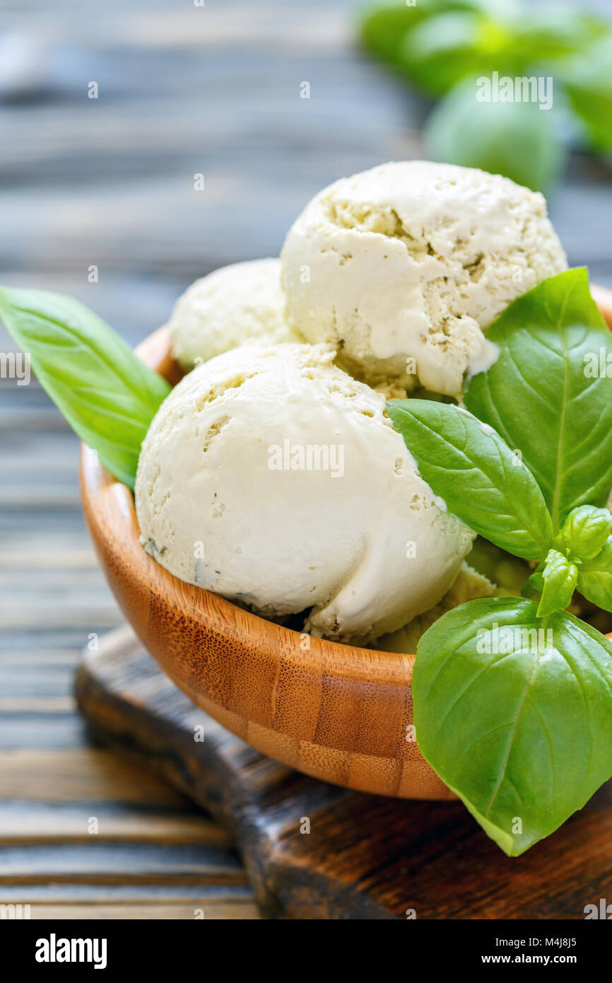 Wooden bowl with a refreshing basil ice cream. Stock Photo