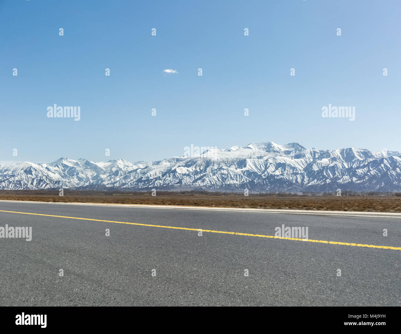 snow mountain with empty asphalt road Stock Photo