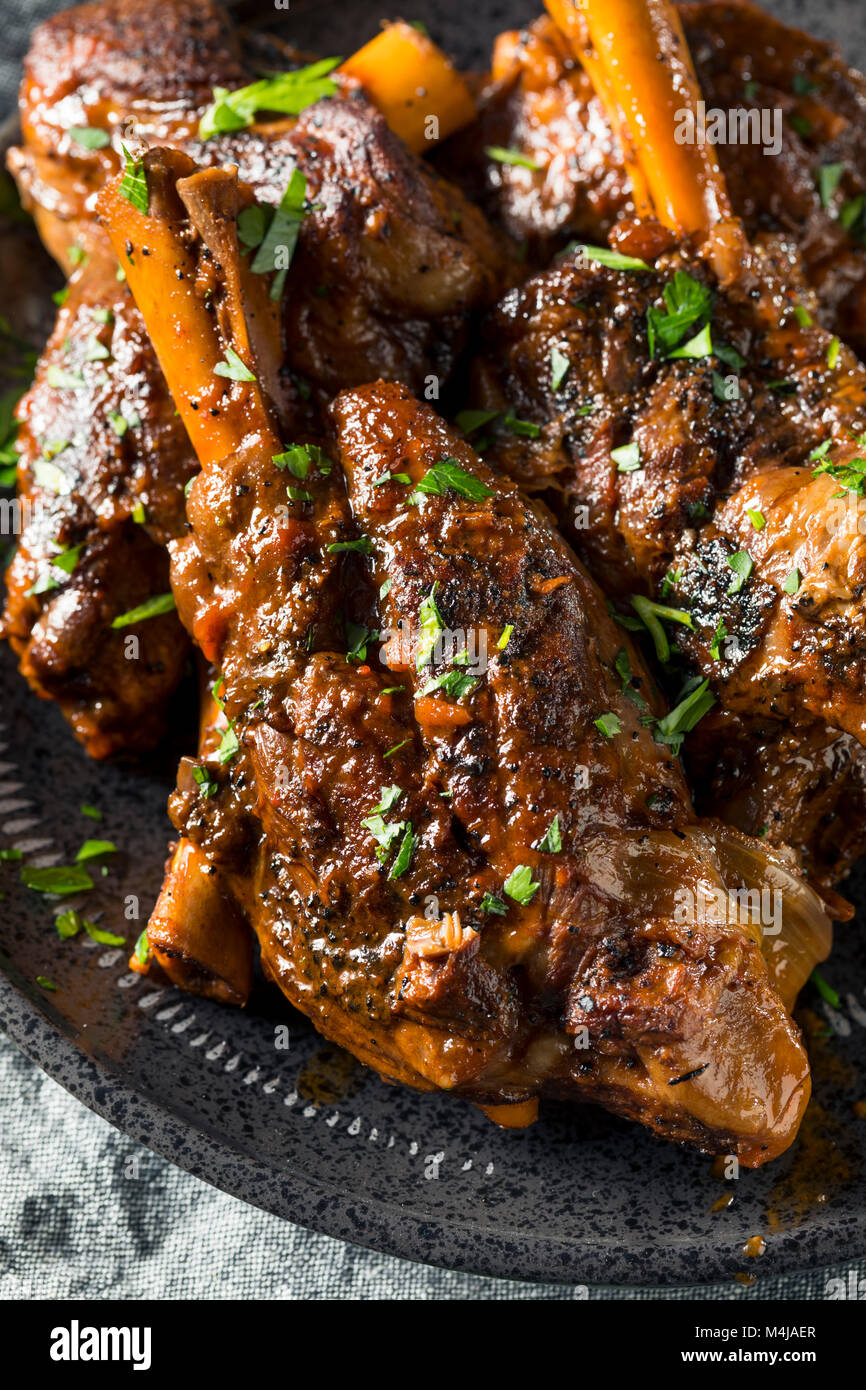 Homemade Braised Lamb Shanks with Sauce and Herbs Stock Photo Alamy