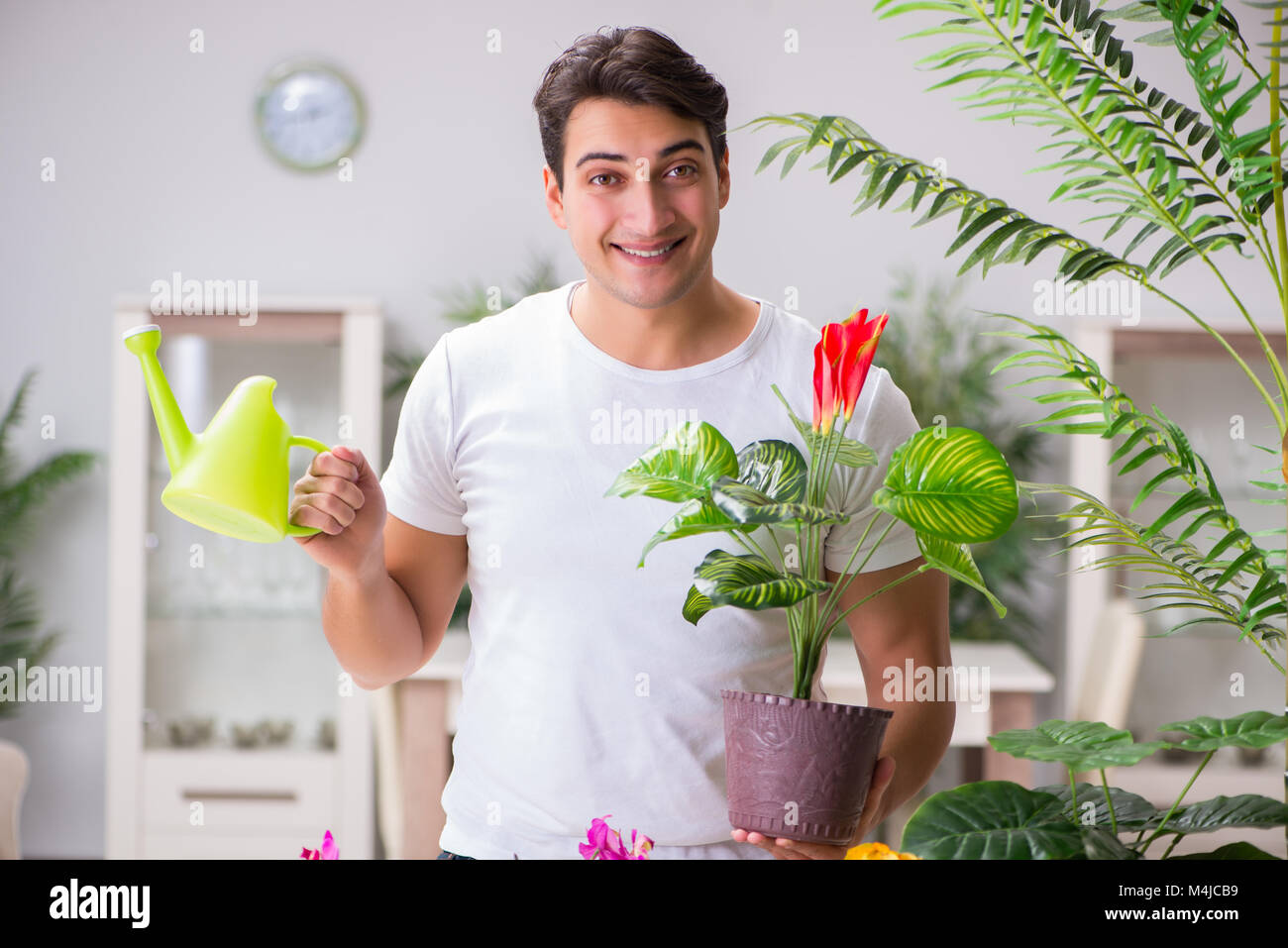 Young man in gardening concept at home Stock Photo
