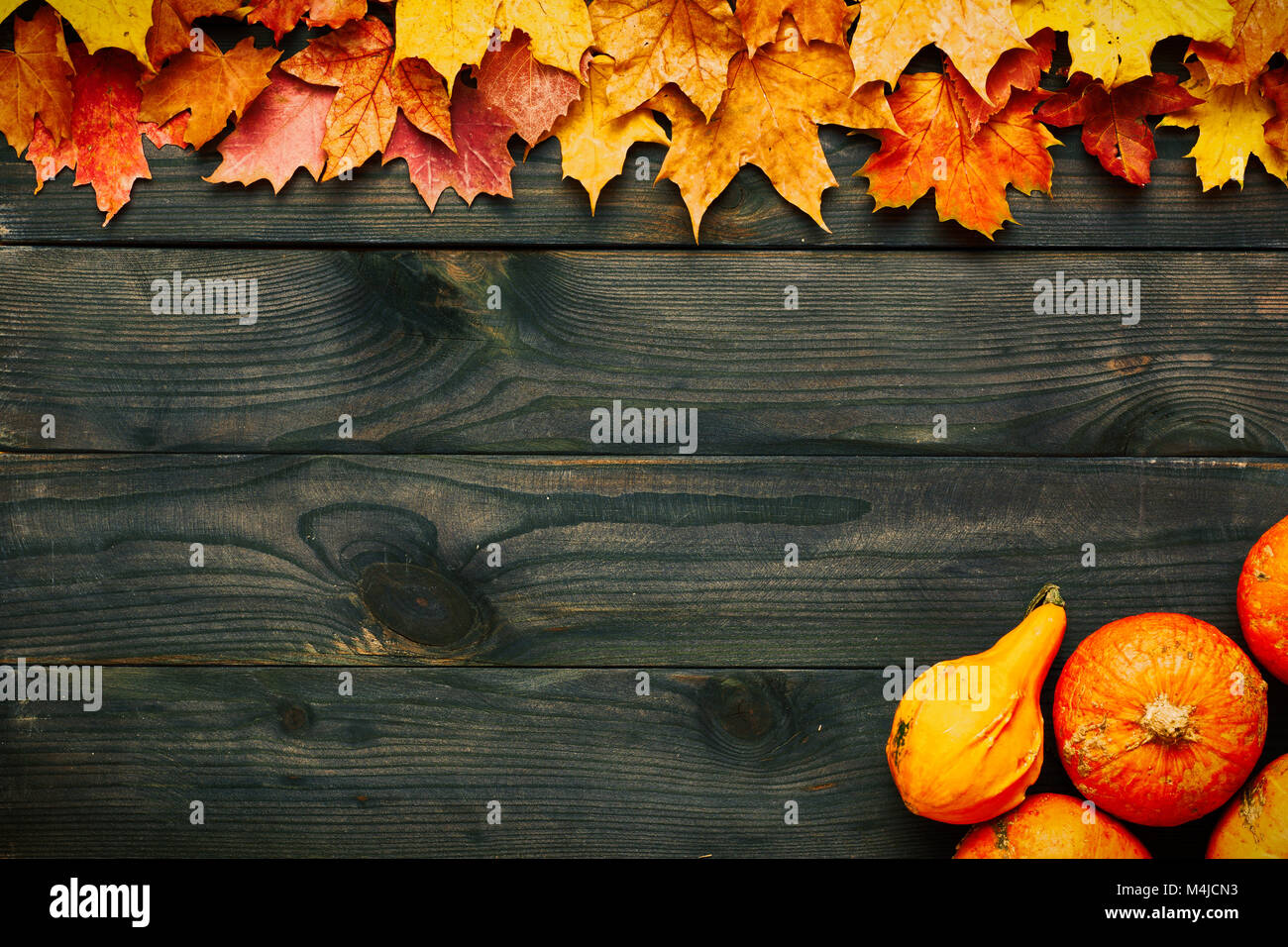 Autumn leaves and pumpkins over old wooden background Stock Photo - Alamy