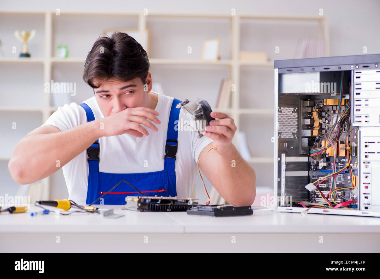 Computer repairman repairing desktop computer Stock Photo - Alamy