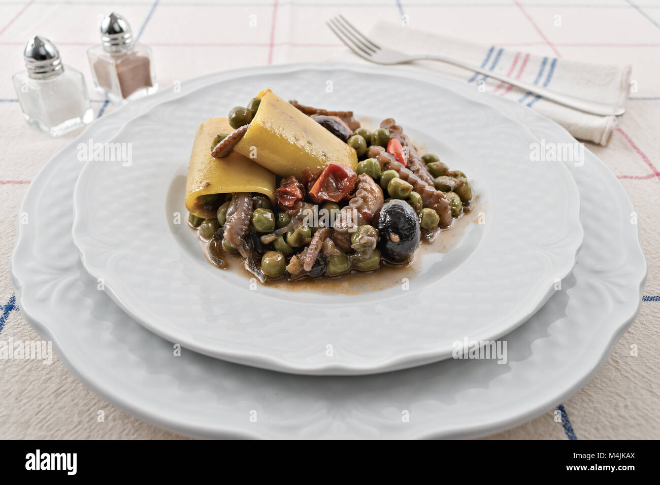 tomato moscardino with peas with paccheri and black olives Stock Photo