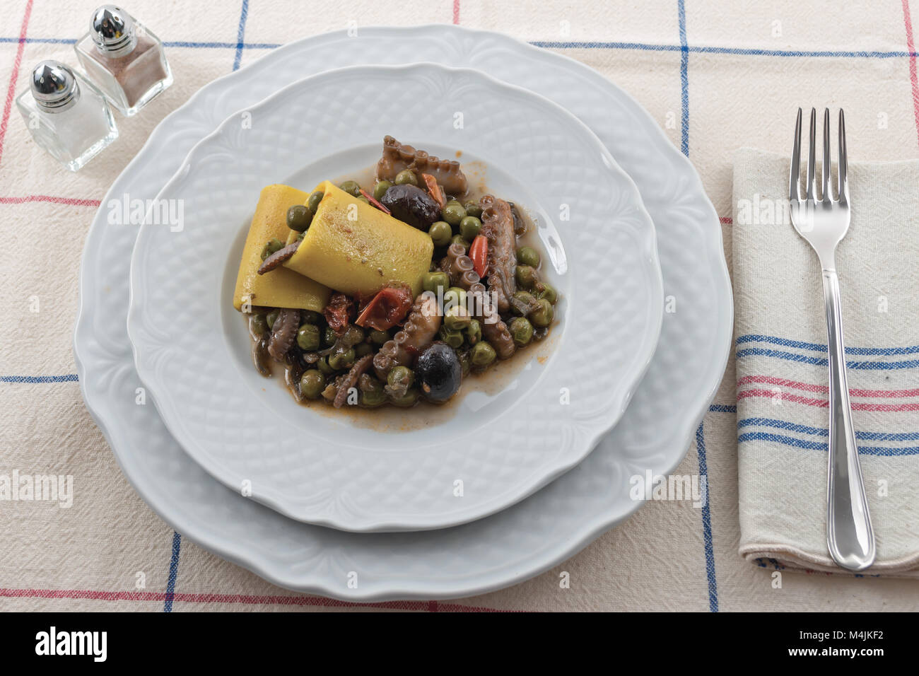 tomato moscardino with peas with paccheri and black olives 2 Stock Photo